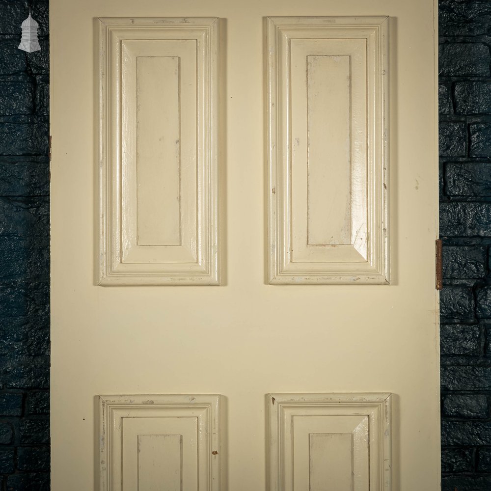 Heavy fire door with mouldings on one side to create panelled appearance.